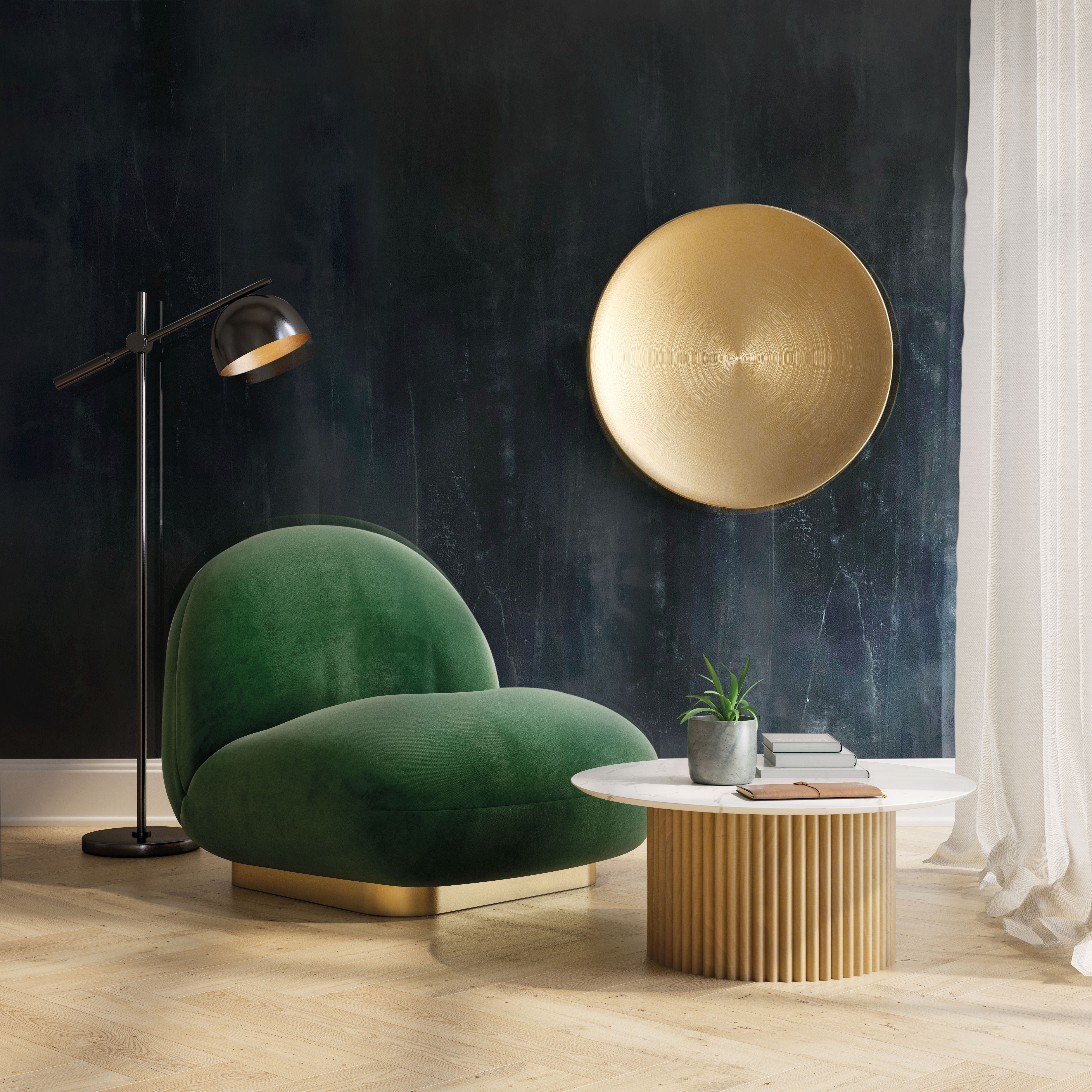 Stylish living room featuring a green chair, gold plate art, and modern decor for a sophisticated ambience.