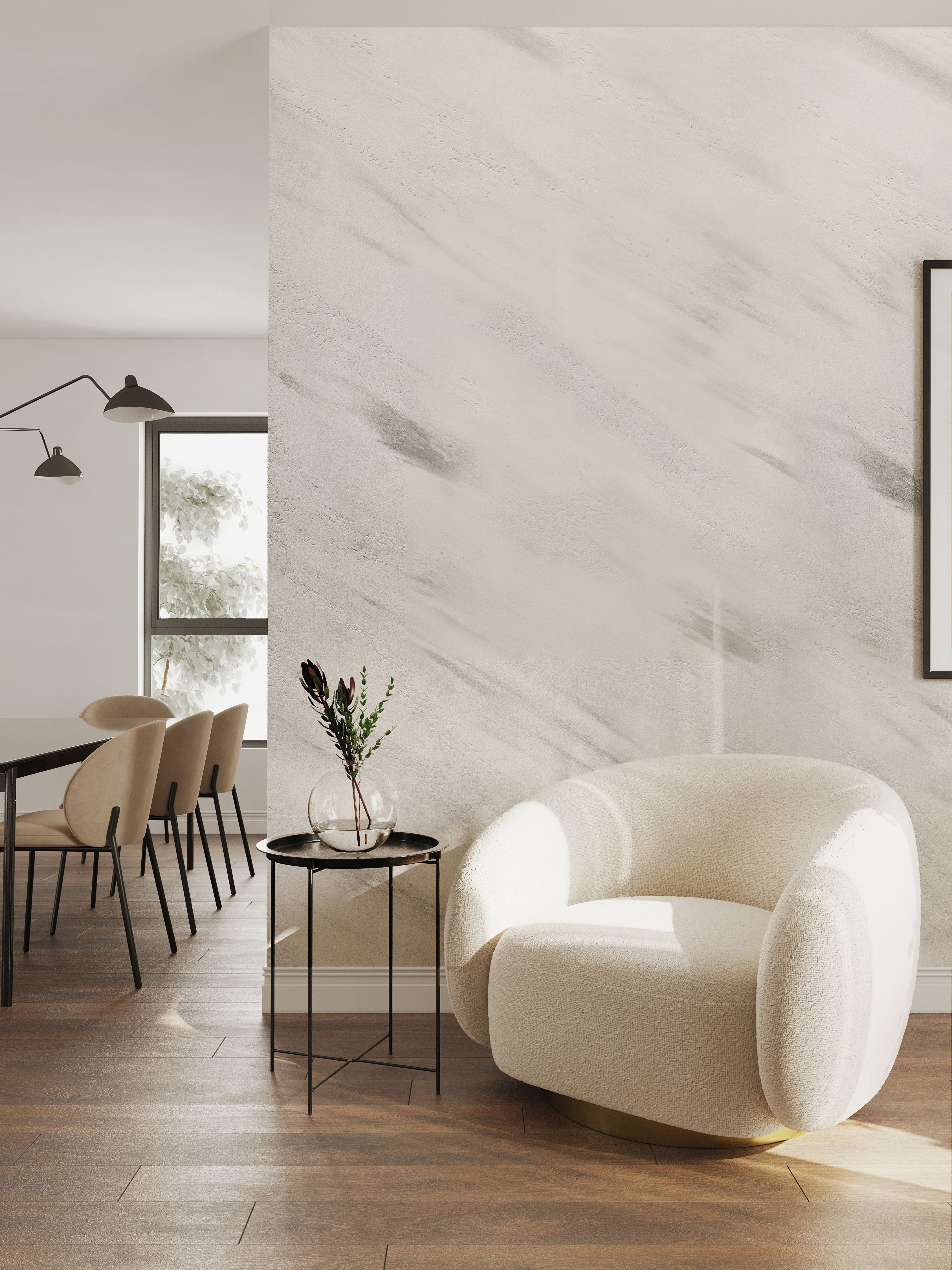 Stylish living room featuring INFINITO Carrara marble finish by Nordflo on the wall, complemented by chic furniture.