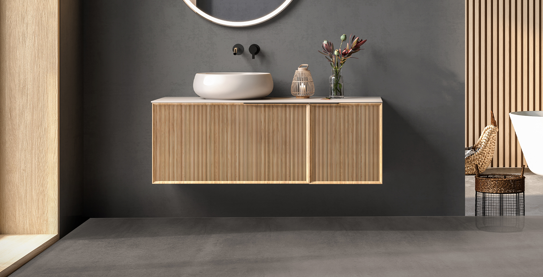 Stylish bathroom featuring ETRON Mikromono 15 kg microcement flooring and modern wooden vanity with sink.