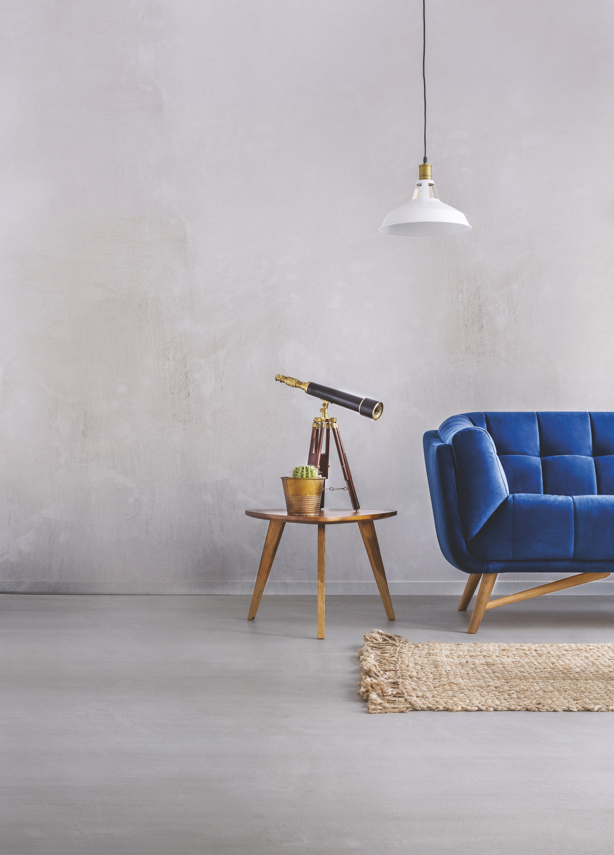 MIKROLOGGIA 15 kg: Modern living space with blue couch, telescope, and stylish decor.