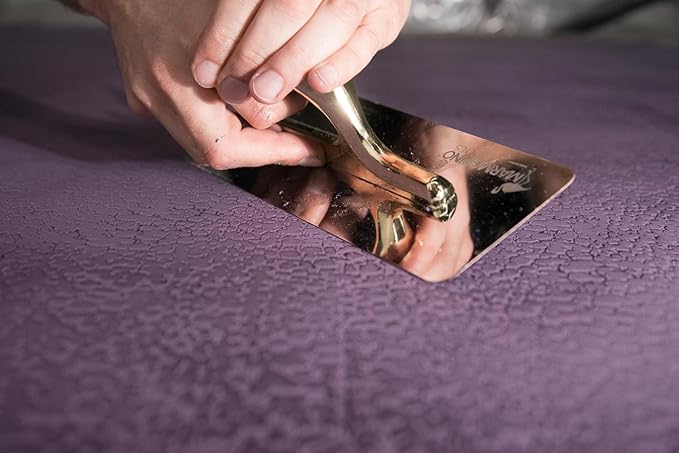 Close-up of hands using Elite Pro Dual Exotic 240/100 mm trowel on mikrosement surface.